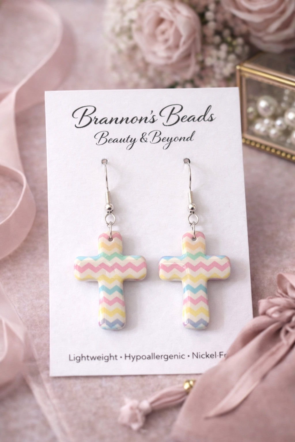 Sweet, soft pastels meet timeless faith with these Pastel Chevron Cross Earrings